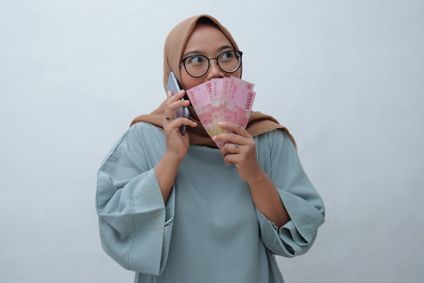 Happy Woman With Indonesian Cash Money And Phone